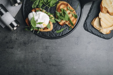 Delicious sandwich with arugula and egg on grey table, flat lay. Space for text