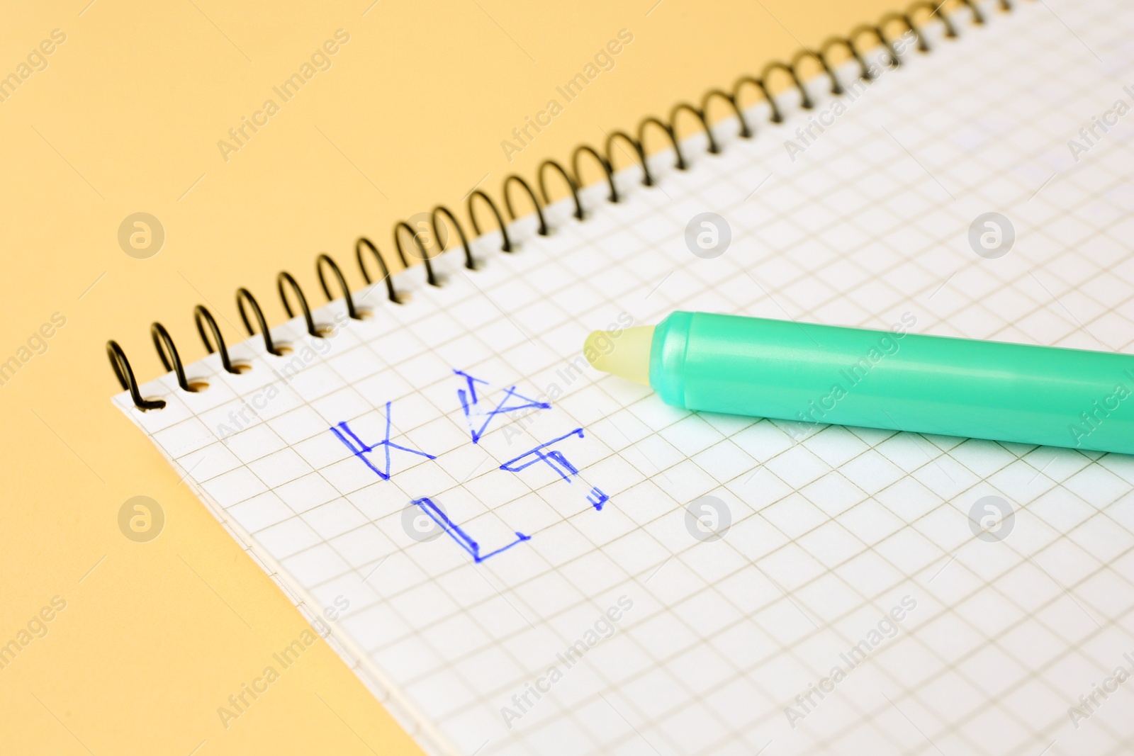 Photo of Letters written in notepad with erasable pen on beige background, closeup
