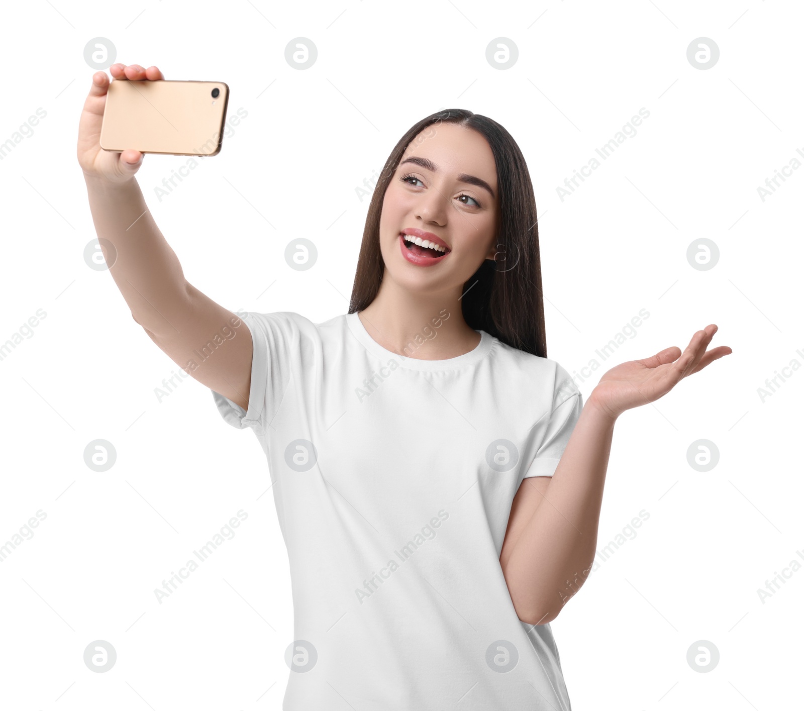 Photo of Smiling young woman taking selfie with smartphone on white background