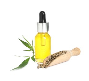 Photo of Bottle of hemp oil, leaves and seeds on white background