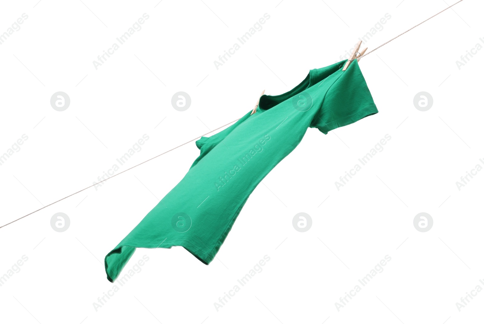 Photo of One green t-shirt drying on washing line isolated on white