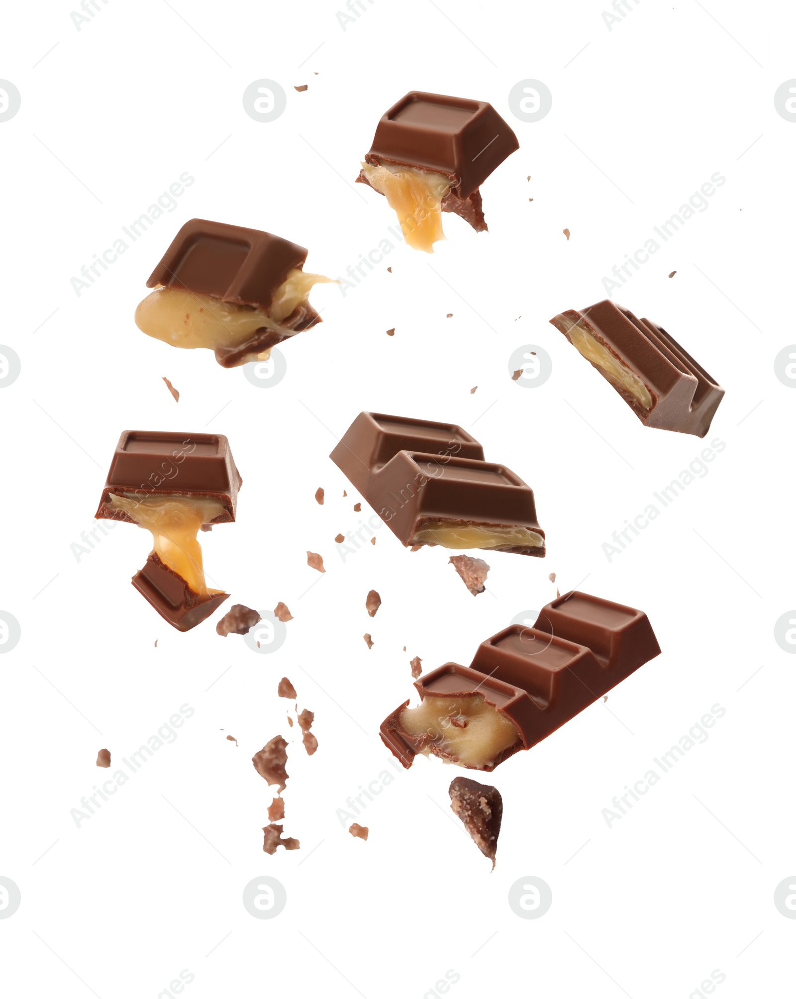 Image of Pieces of delicious chocolate bars with caramel falling on white background