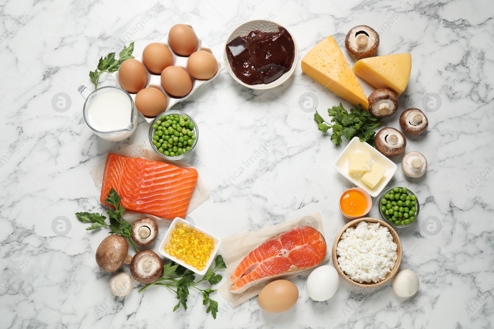 Photo of Flat lay composition with products rich in vitamin D on white marble table. Space for text