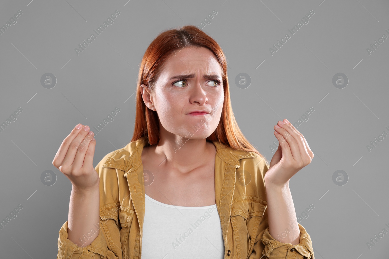 Photo of Casting call. Emotional woman performing on grey background