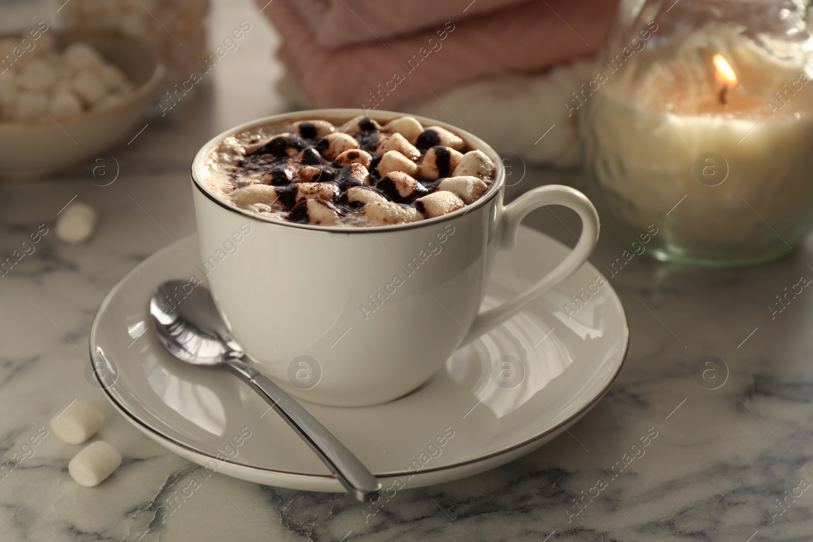 Photo of Cup of aromatic hot chocolate with marshmallows served on light marble table, closeup