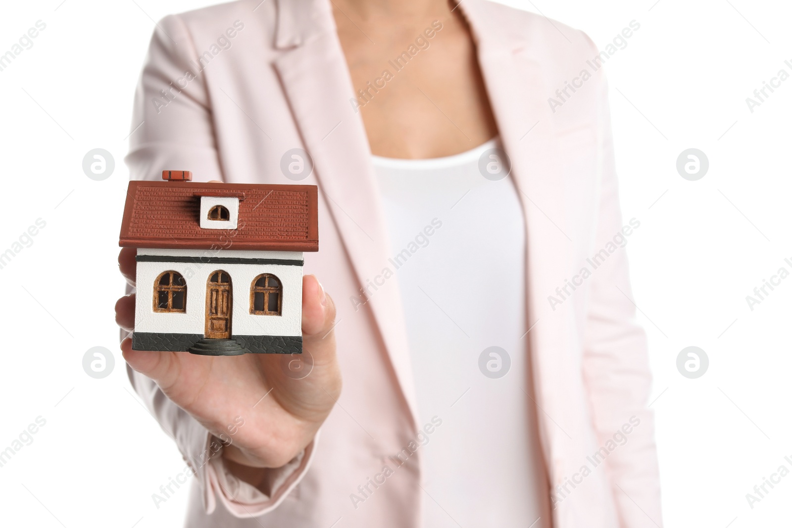 Photo of Real estate agent holding house model on white background