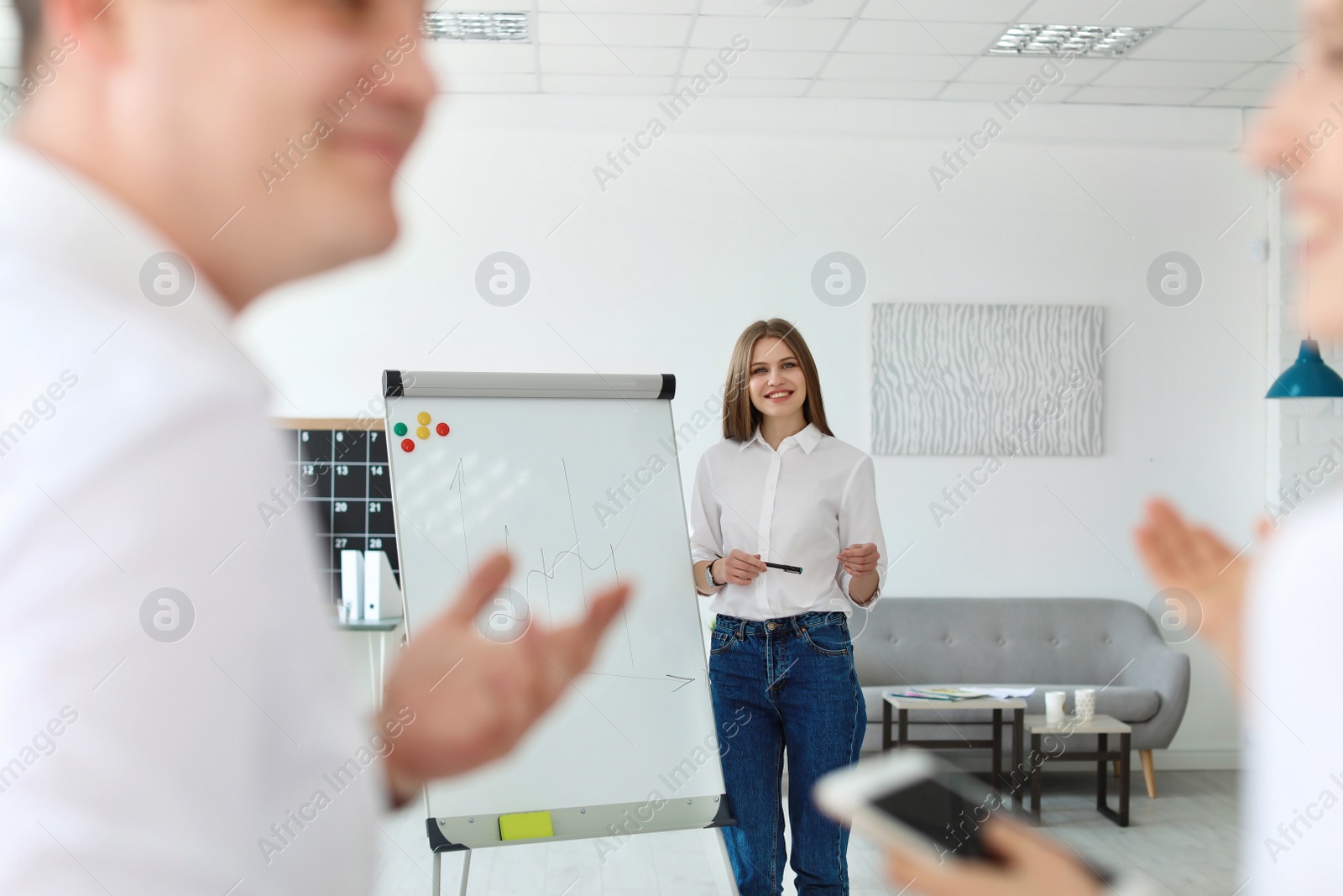 Photo of Female business trainer giving lecture in office