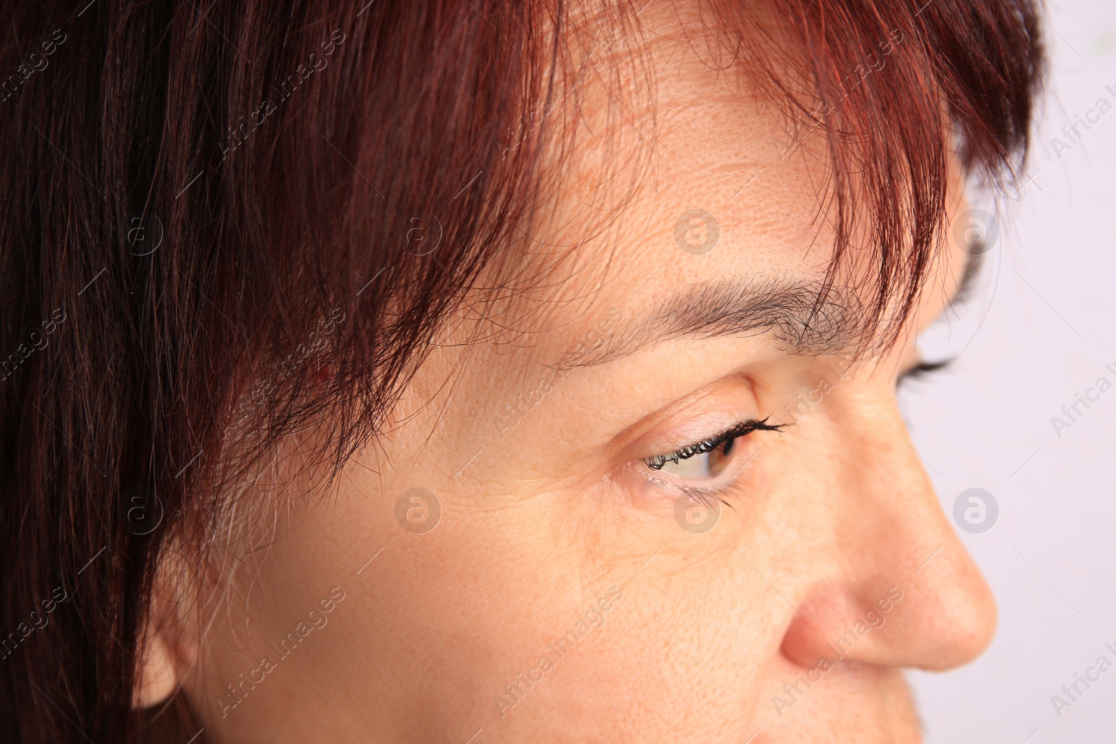 Photo of Closeup view of older woman on white background