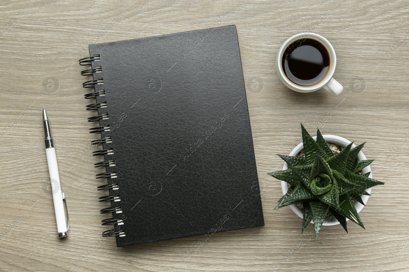 Photo of Flat lay composition with notebook on light wooden table