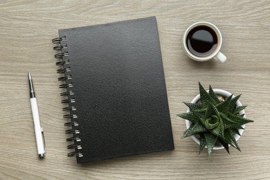 Flat lay composition with notebook on light wooden table