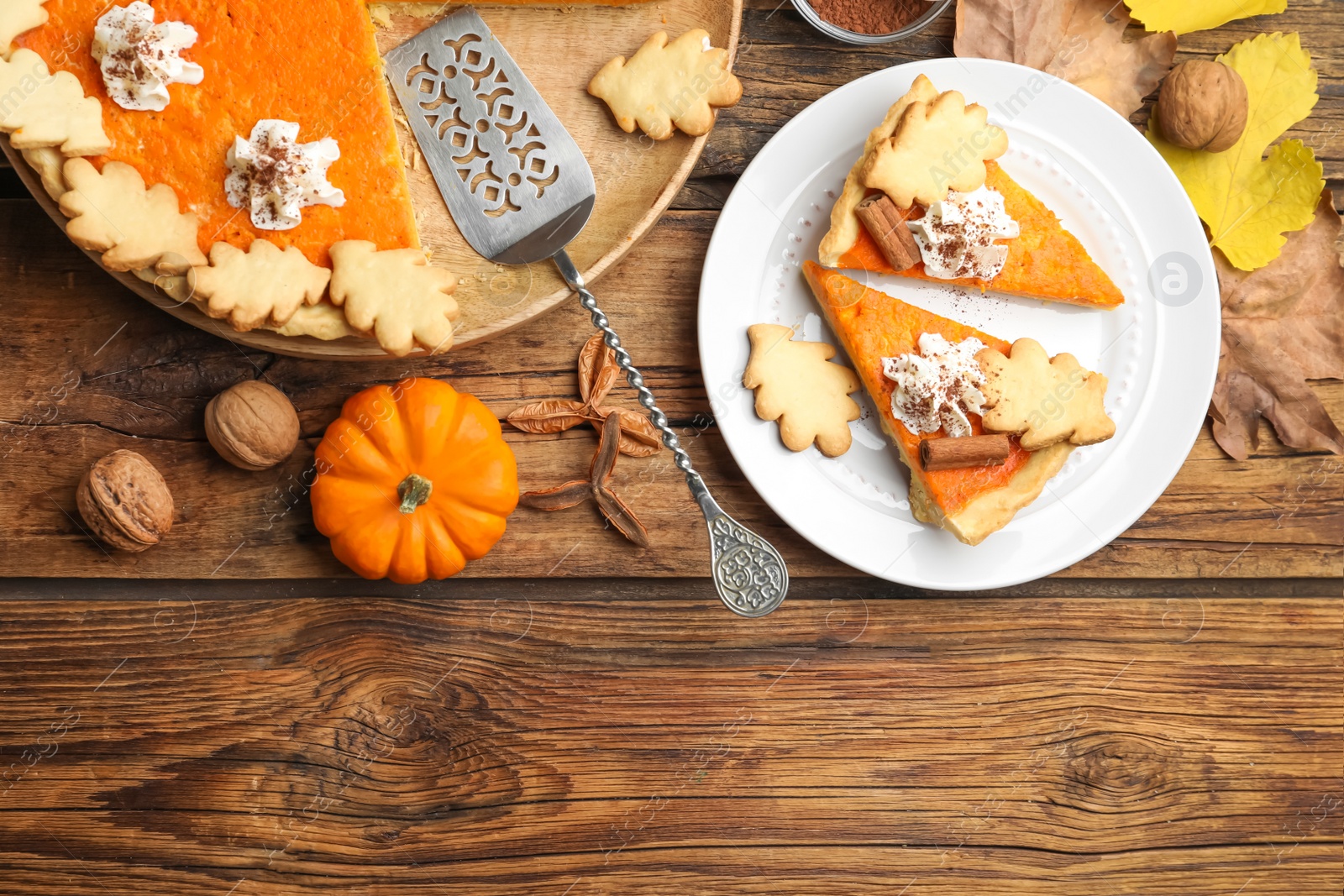 Photo of Delicious homemade pumpkin pie on wooden table, flat lay. Space for text