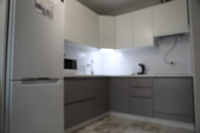 Photo of Blurred view of stylish modern kitchen interior