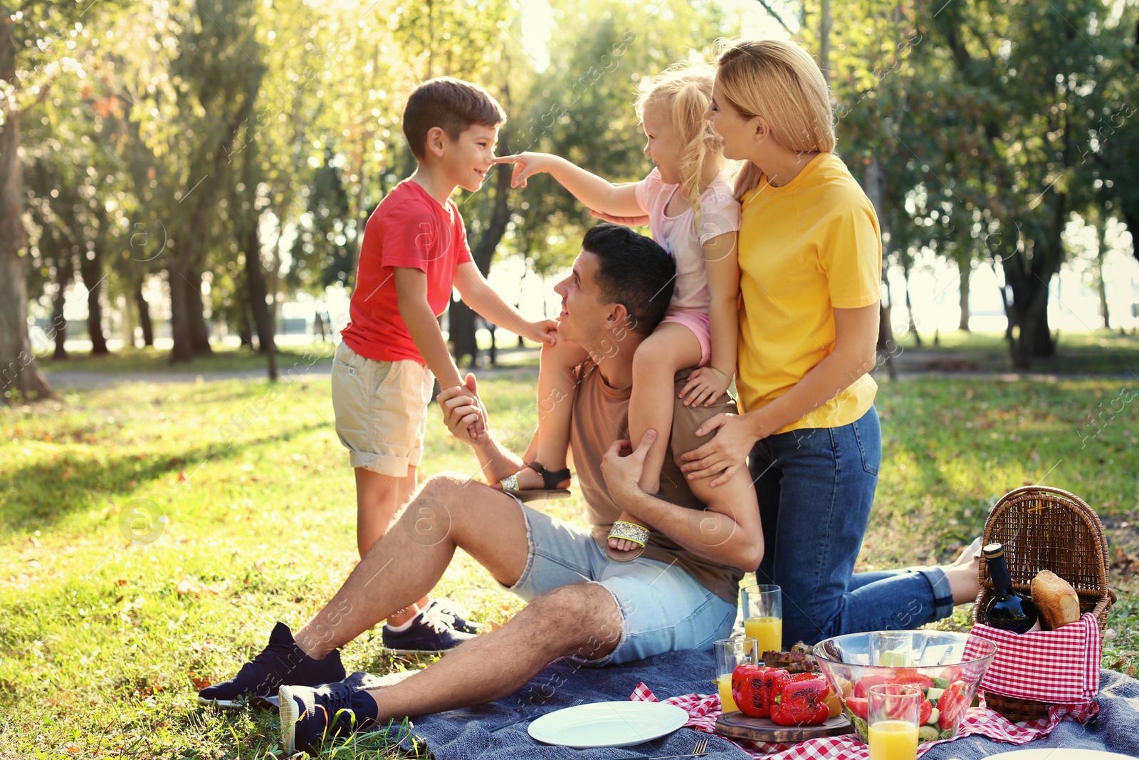 Photo of Happy family having picnic in park on sunny day