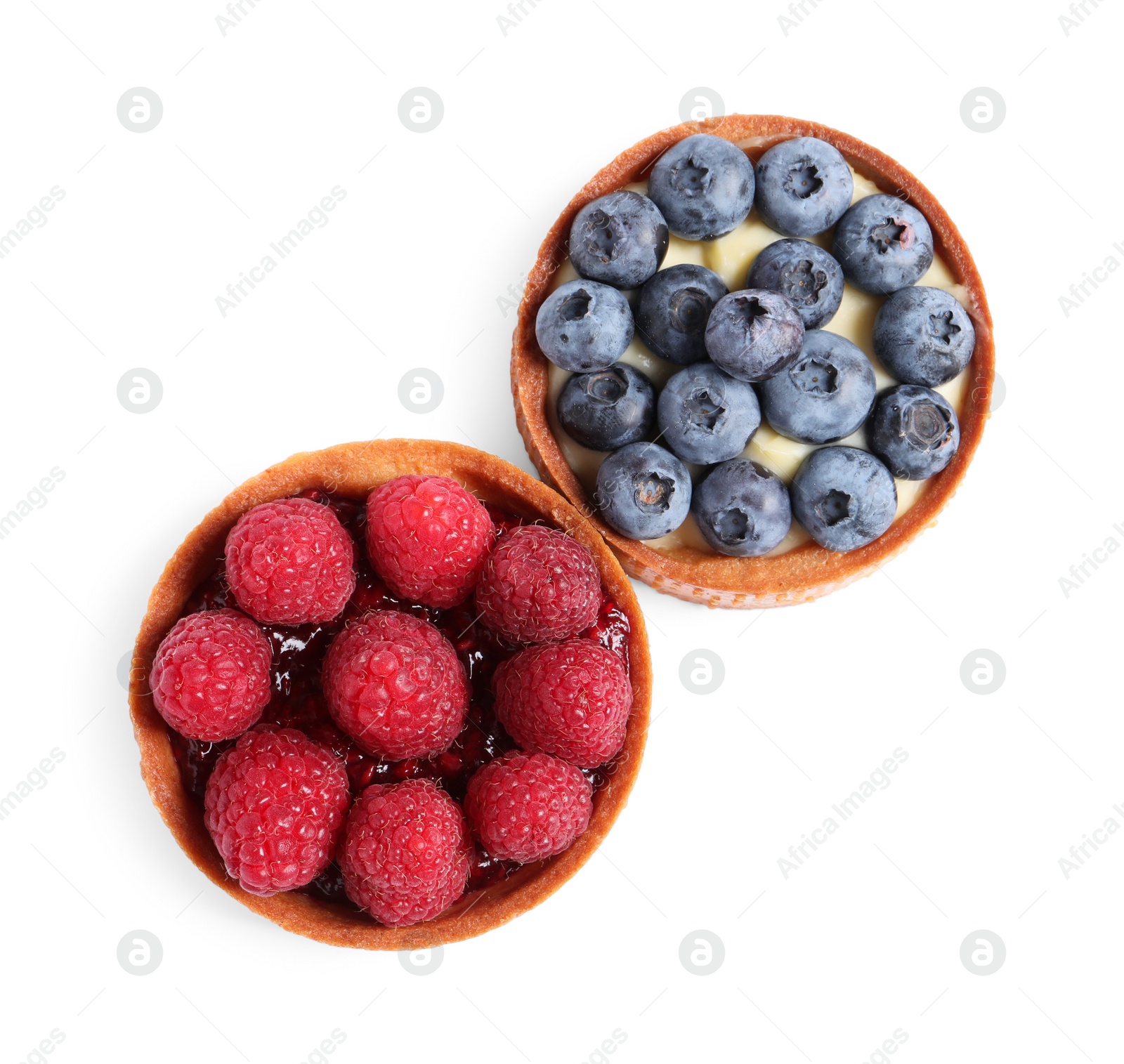 Photo of Tartlets with different fresh berries isolated on white, top view. Delicious dessert