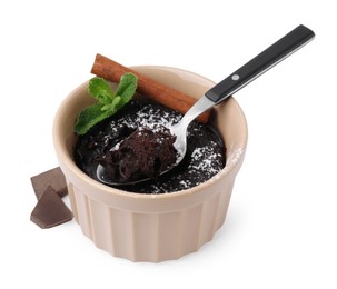 Tasty chocolate pie with cinnamon stick, mint and spoon isolated on white. Microwave cake recipe