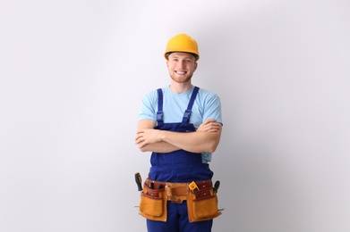 Photo of Professional technician near modern air conditioner indoors