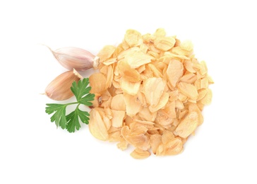 Photo of Dried garlic flakes and parsley on white background, top view