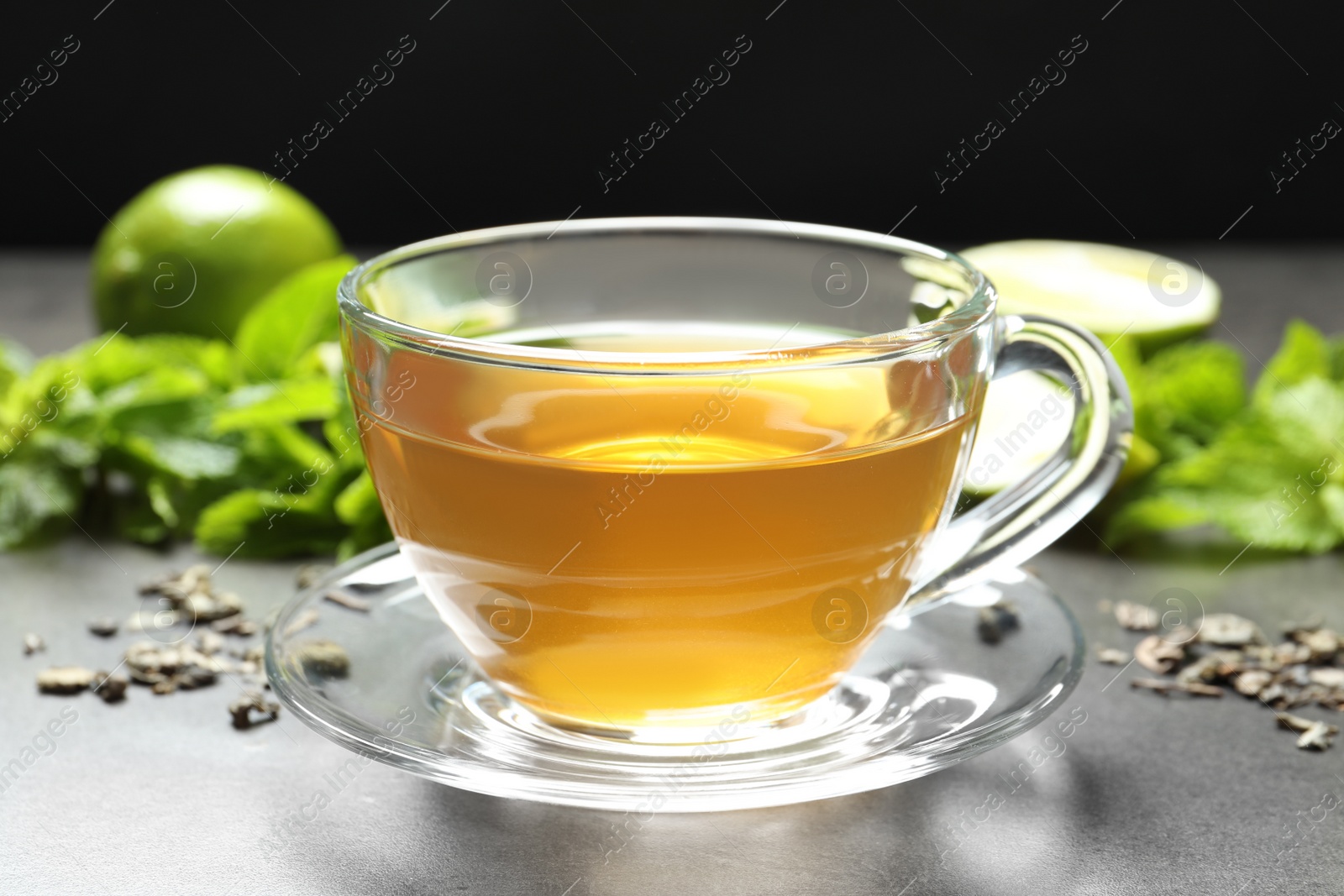 Photo of Cup with hot aromatic mint tea on table