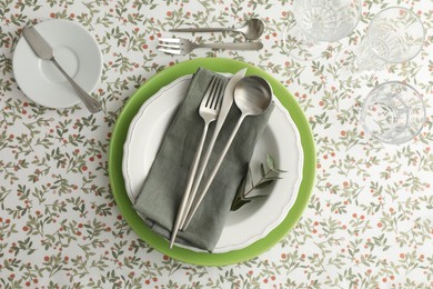 Stylish setting with cutlery, plates, napkin and glasses on table, flat lay