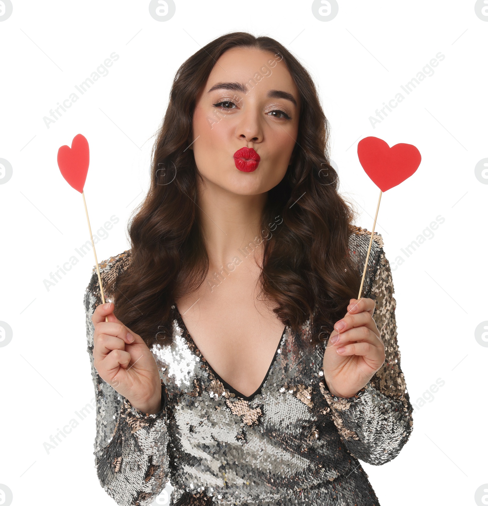 Photo of Beautiful young woman with paper hearts sending air kiss isolated on white