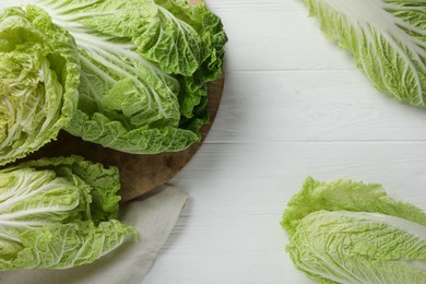 Fresh ripe Chinese cabbages on white wooden table, flat lay