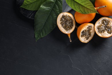 Delicious ripe granadillas on black table, above view. Space for text