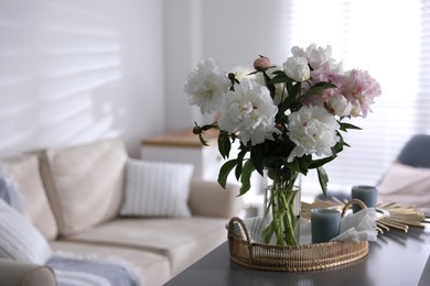 Bouquet of beautiful peony flowers on table indoors