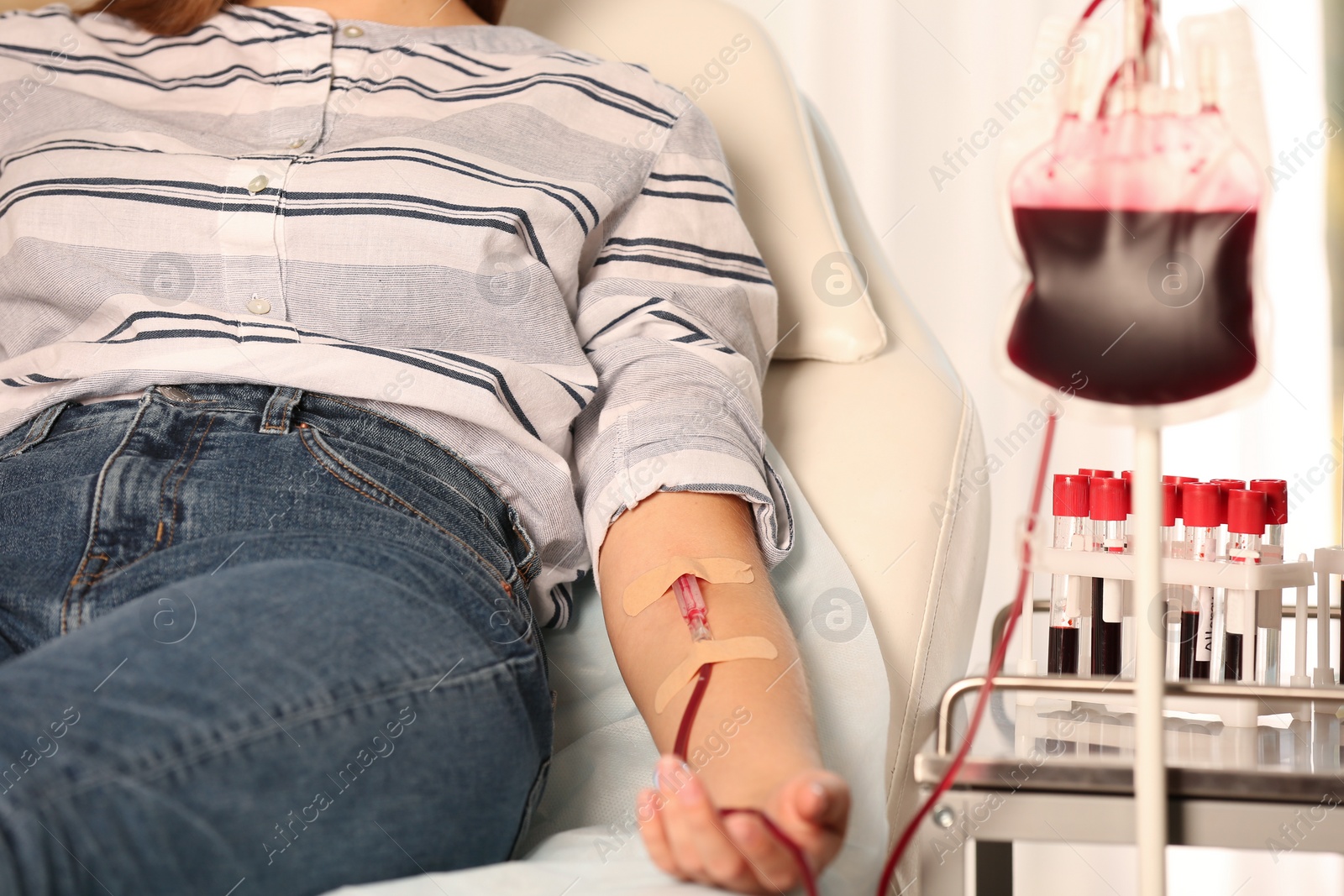 Photo of Woman making blood donation at hospital, closeup