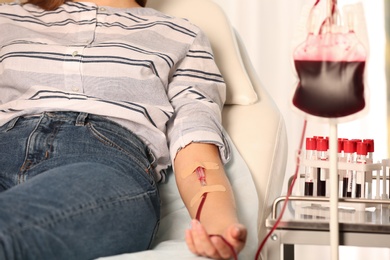 Woman making blood donation at hospital, closeup