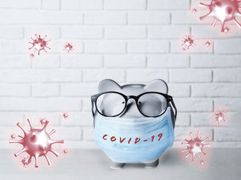 Piggy bank with medical mask. Money saving during coronavirus outbreak