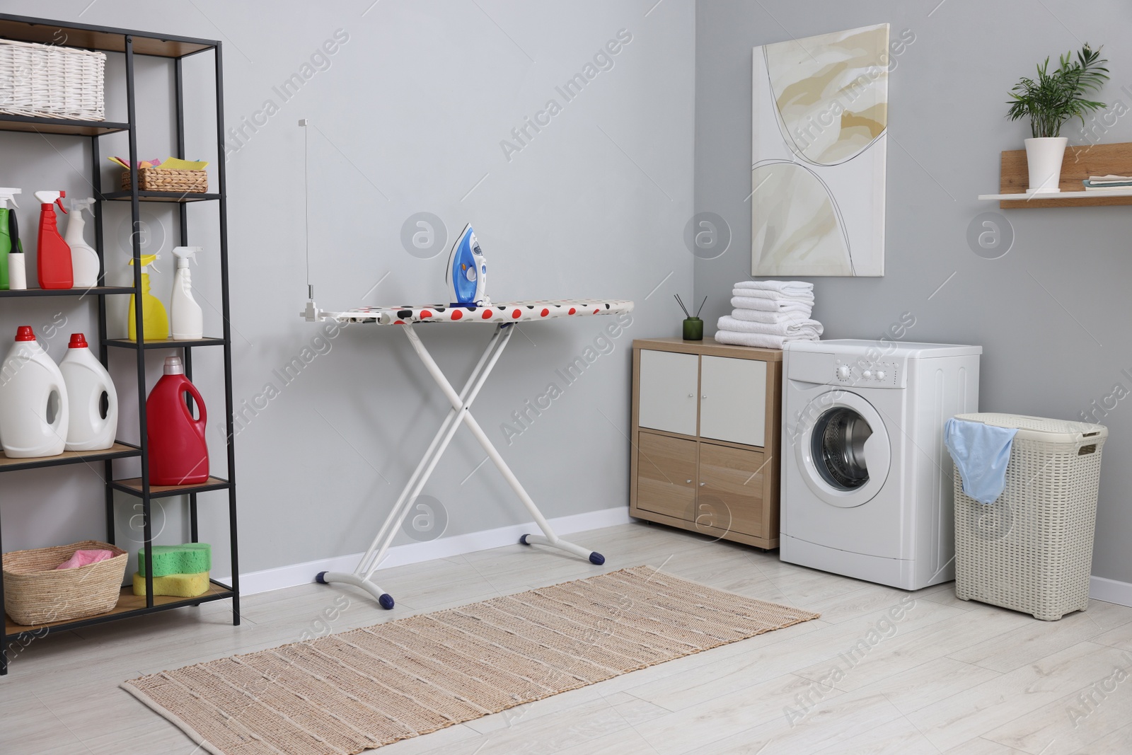 Photo of Laundry room interior with washing machine and furniture