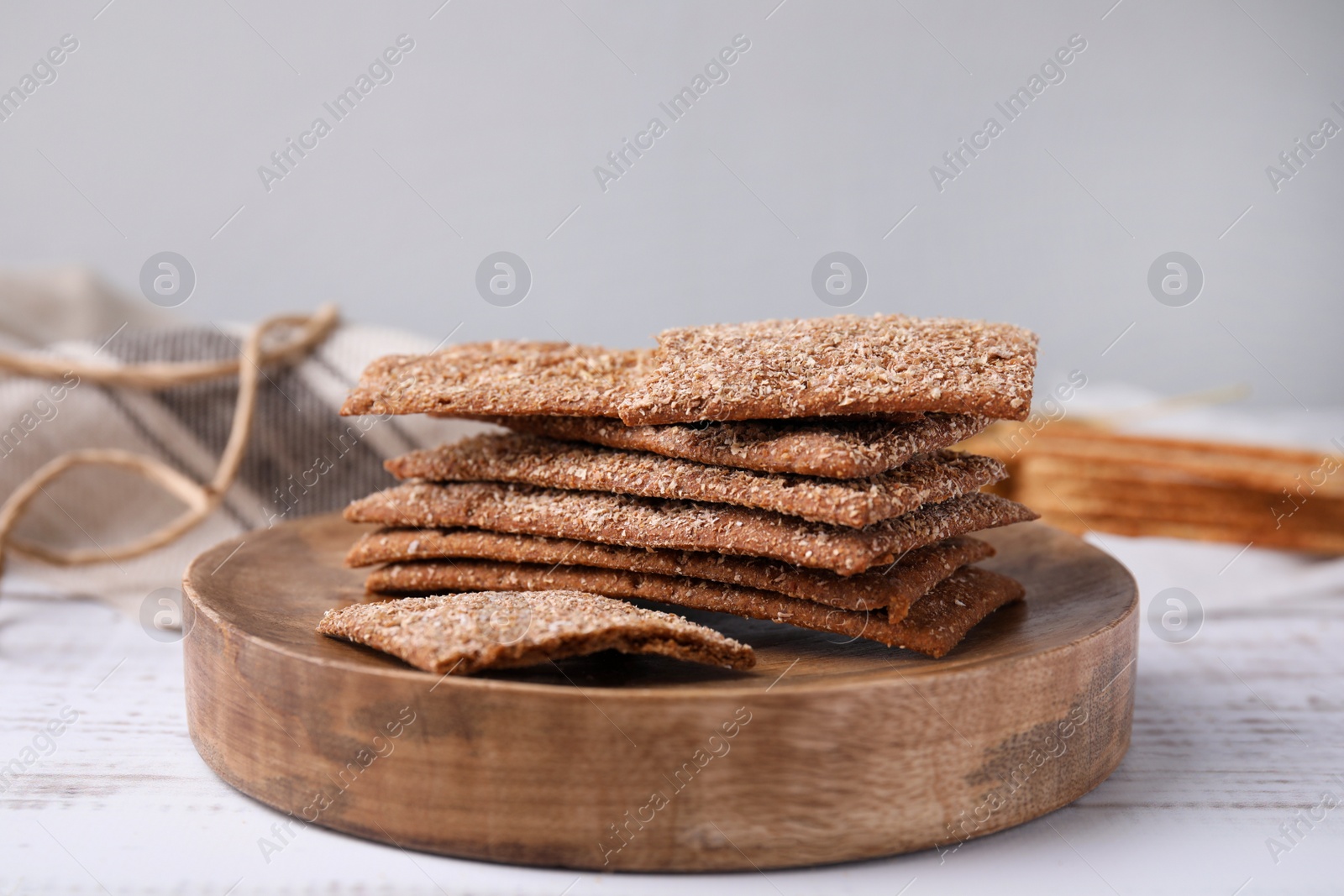 Photo of Stack of dry rye crispbreads on white wooden table