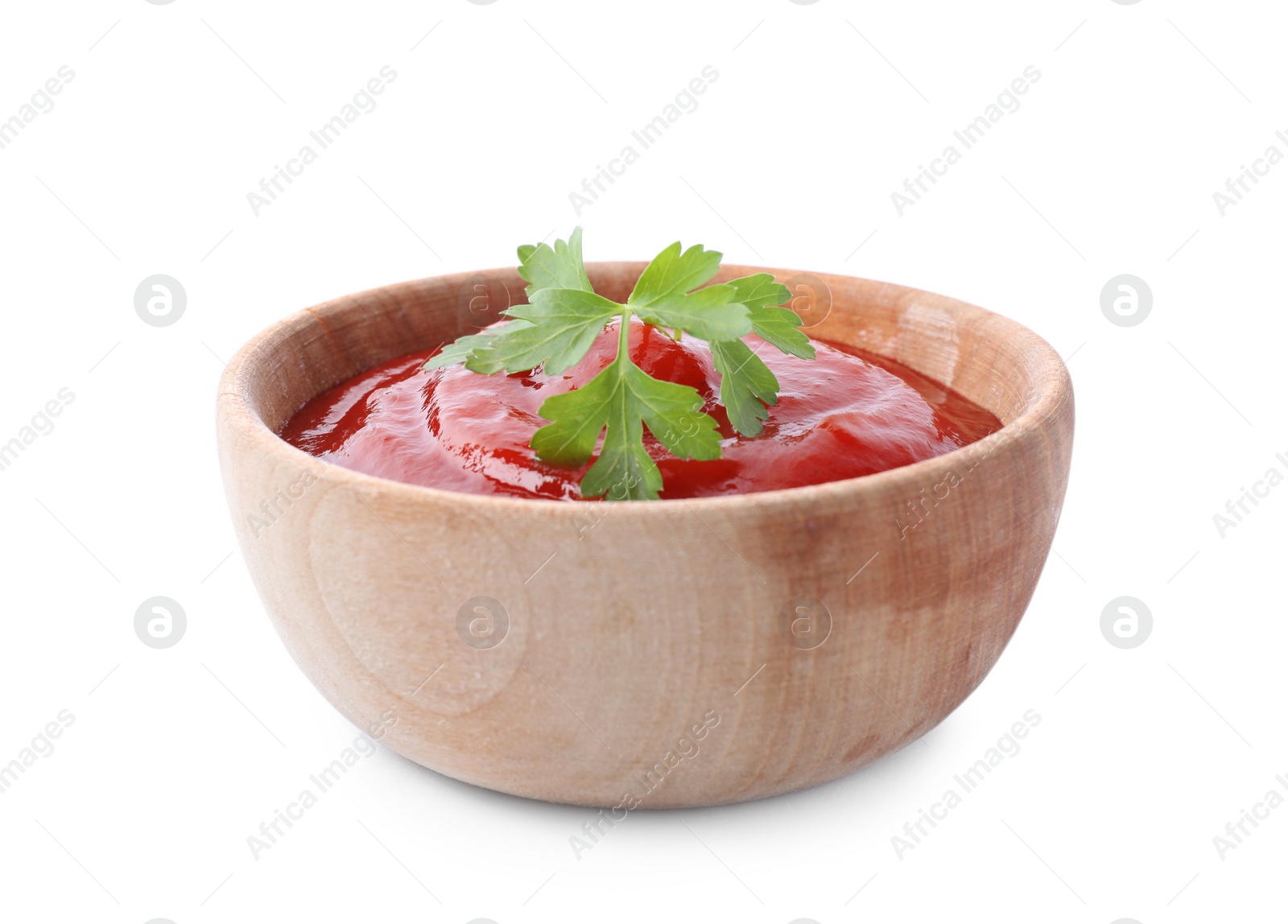 Photo of Tasty tomato sauce with parsley in wooden bowl isolated on white