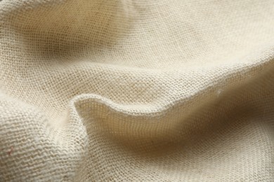Photo of Texture of beige crumpled fabric as background, closeup