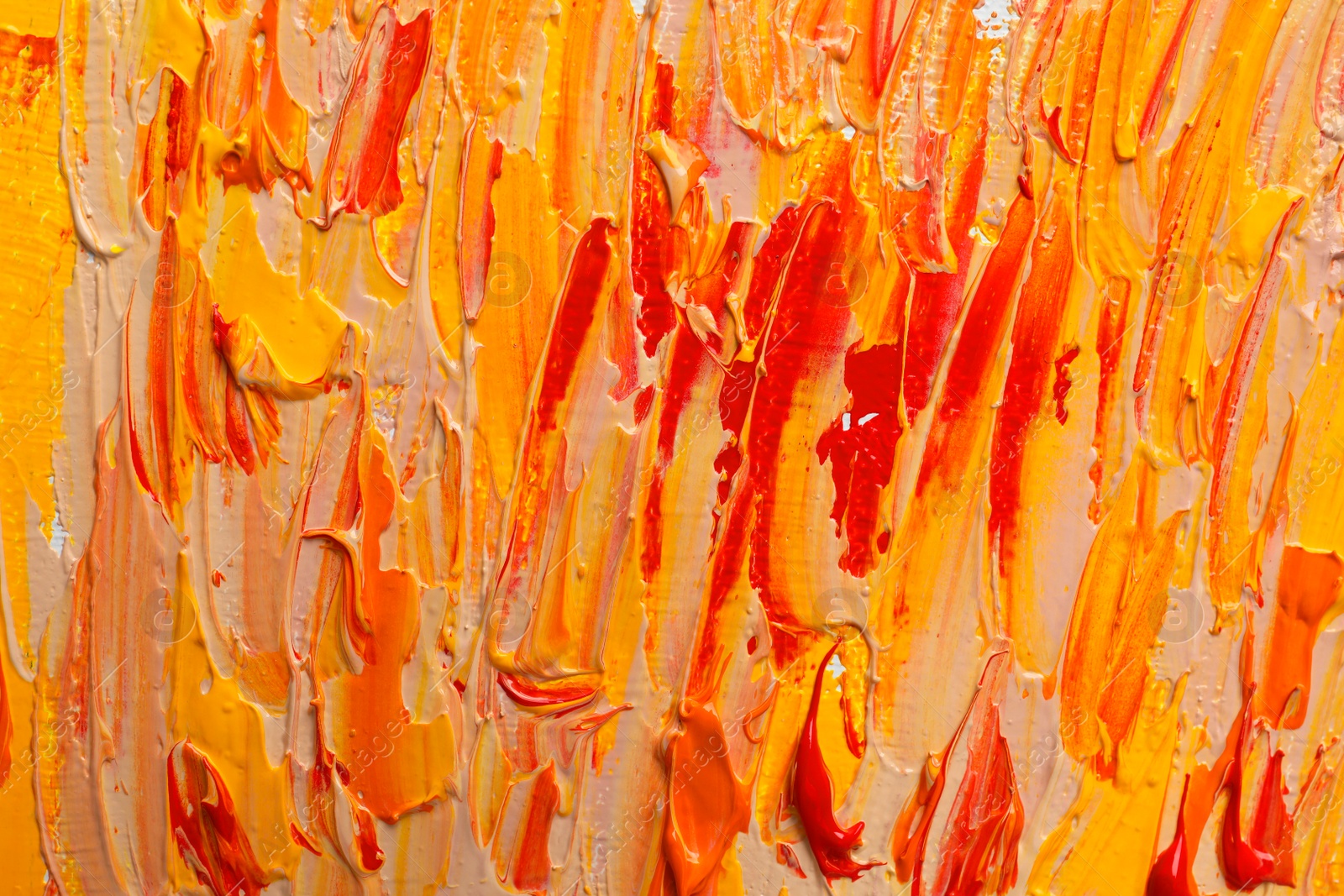 Photo of Strokes of colorful oil paints as background, closeup