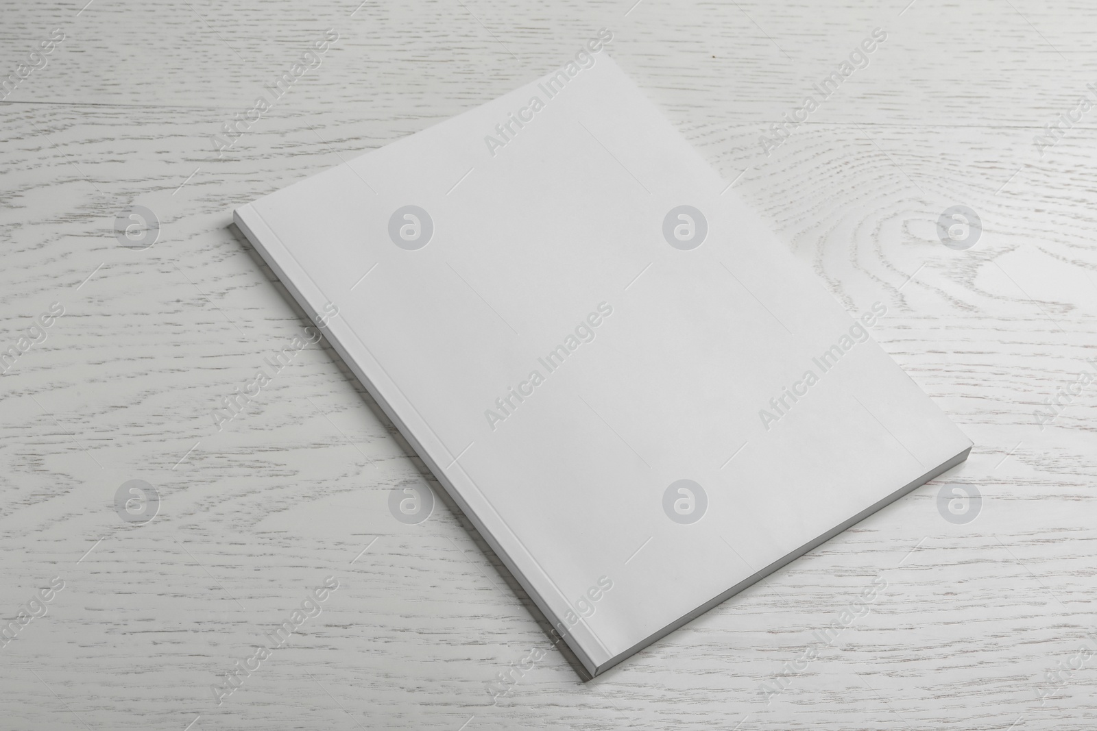 Photo of Brochure with blank cover on wooden background. Mock up for design