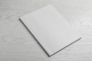 Brochure with blank cover on wooden background. Mock up for design