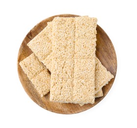 Wooden board with tasty sesame kozinaki bars on white background, top view