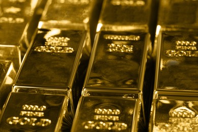 Many shiny gold bars as background, closeup