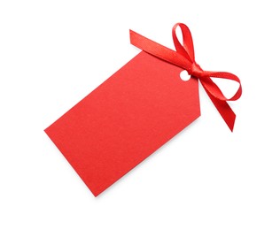 Photo of Blank red gift tag with satin ribbon on white background, top view