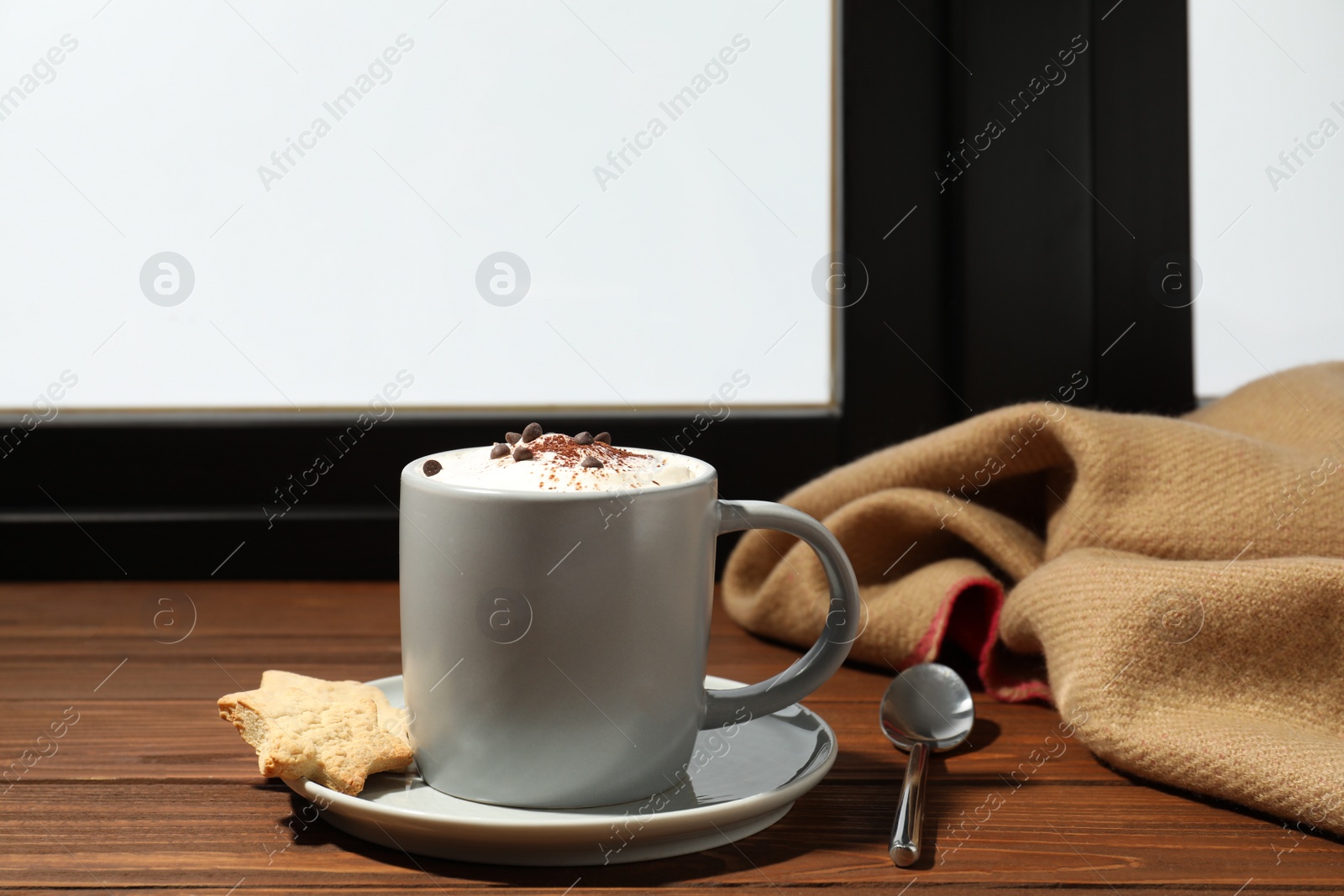 Photo of Cup of cappuccino with cookies on windowsill indoors, space for text. Winter drink