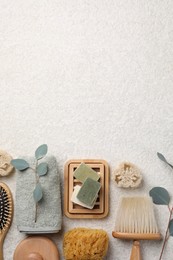 Photo of Flat lay composition with different spa products and eucalyptus branches on light grey textured table. Space for text