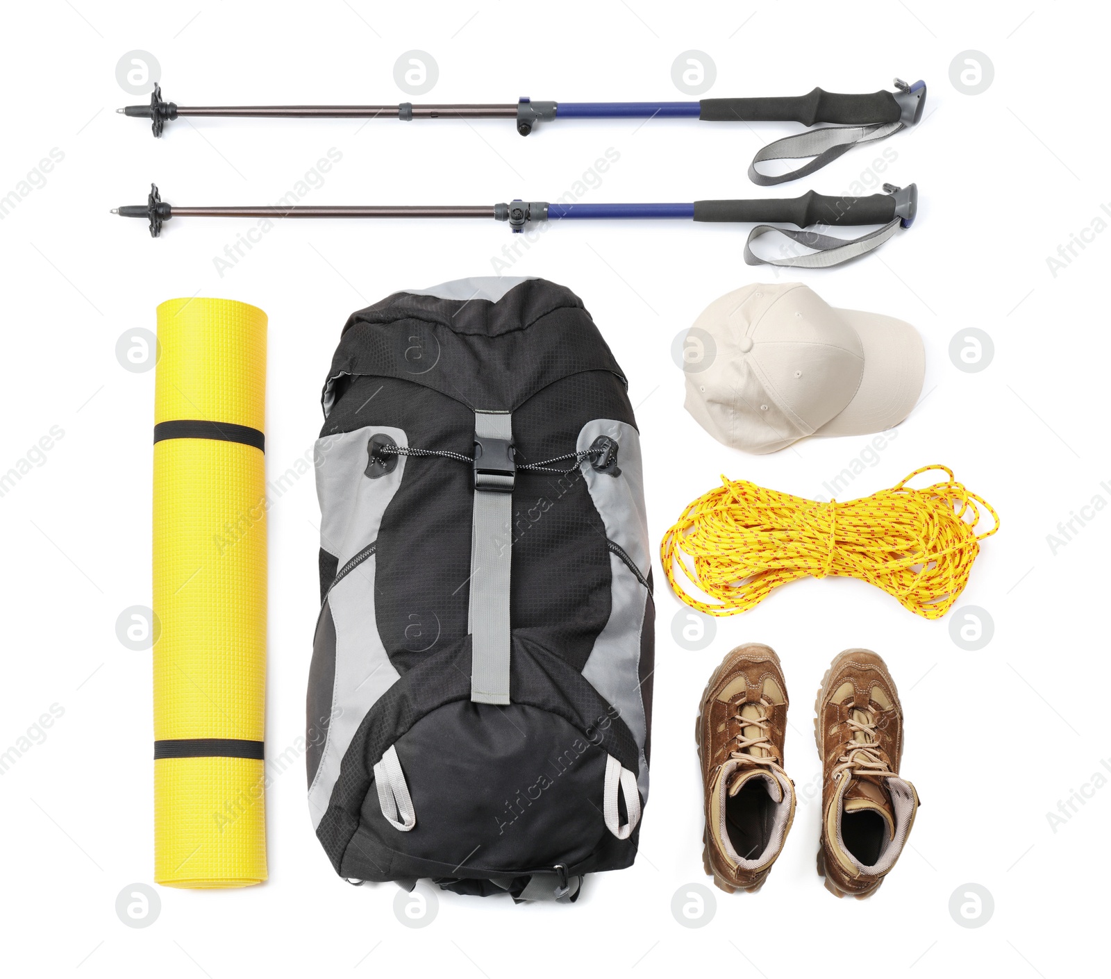 Photo of Pair of trekking poles and camping equipment for tourism on white background, top view