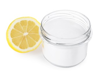 Photo of Baking soda in jar and lemon isolated on white