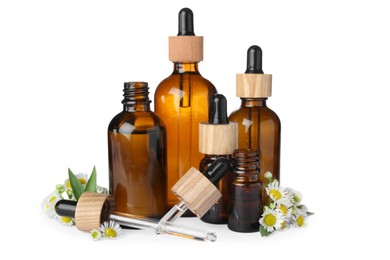 Photo of Bottles of essential oil and beautiful flowers on white background