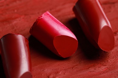 Photo of Closeup view of many bright red lipsticks