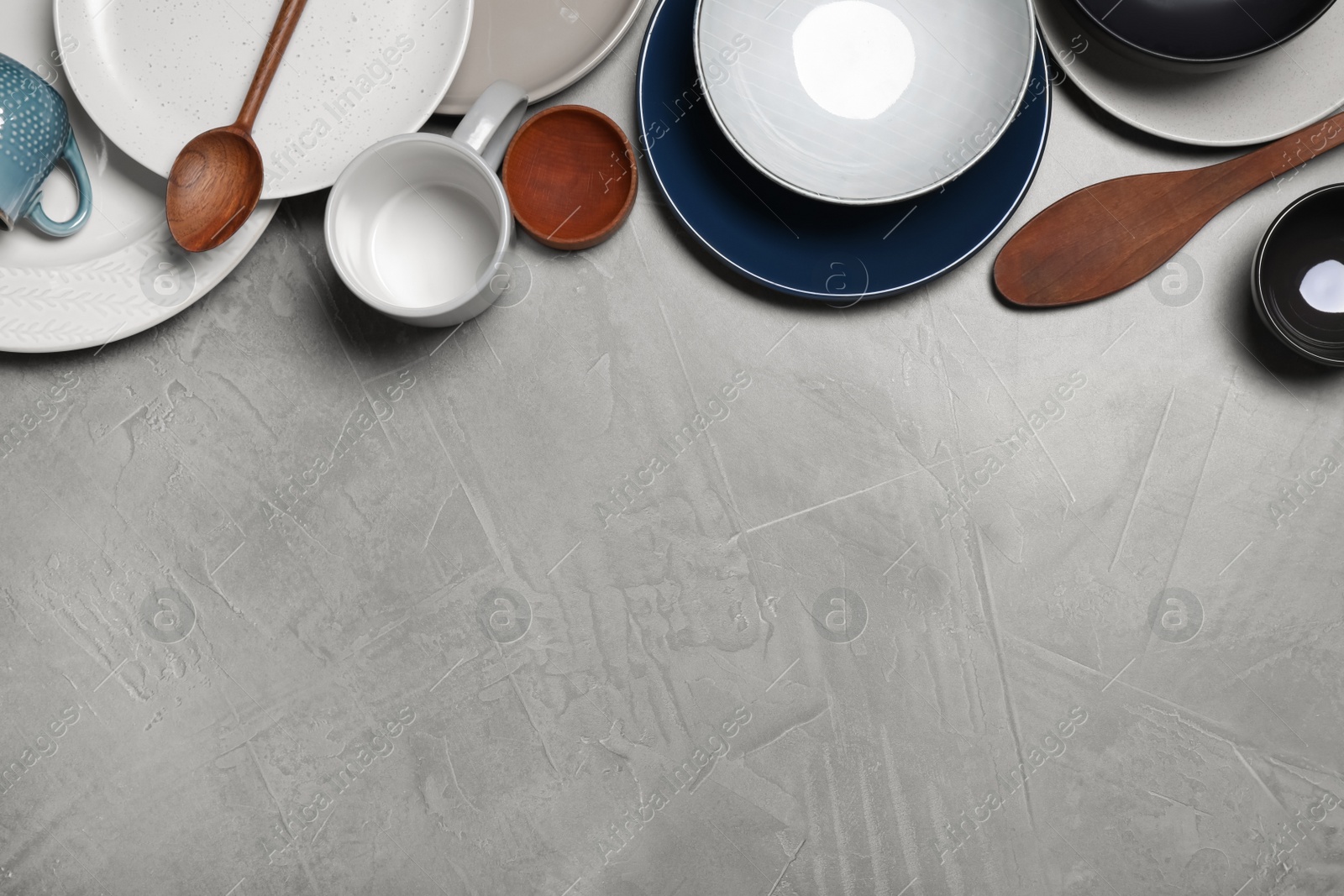 Photo of Flat lay composition with dishware on light grey table. Space for text