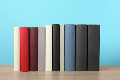 Photo of Many different hardcover books on wooden table