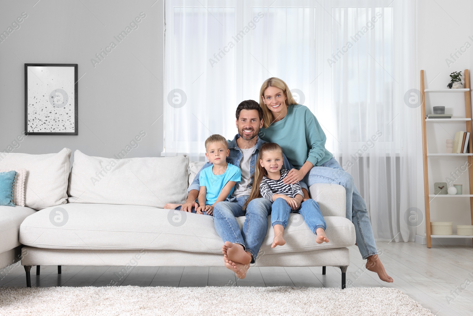 Photo of Portrait of happy family with children on sofa at home