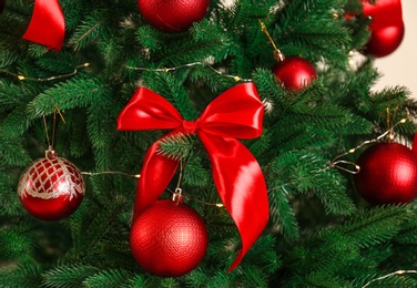 Photo of Beautiful Christmas tree with red decorations, closeup